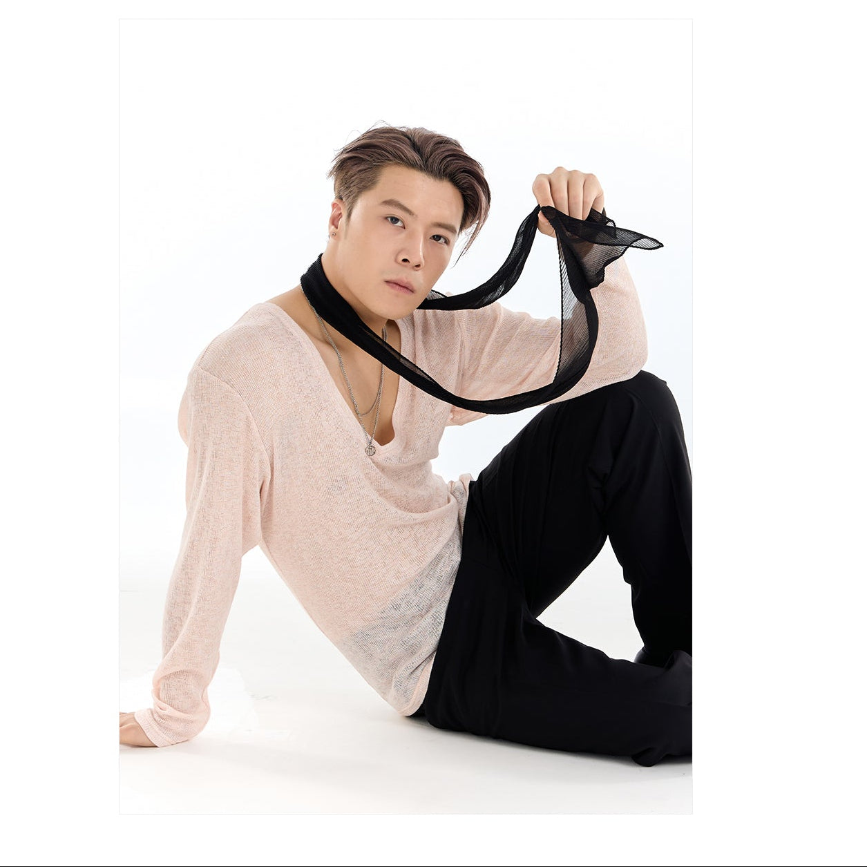 Person holding a black sheer fabric with 'DUYQDESIGN' branding on a white background