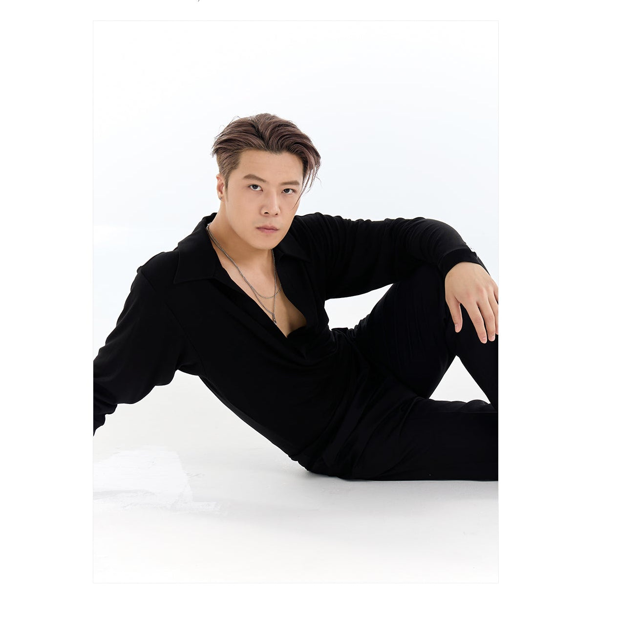 Person wearing a black outfit with a white triangle design on a white background, featuring the brand 'DYQ DESIGN'.
