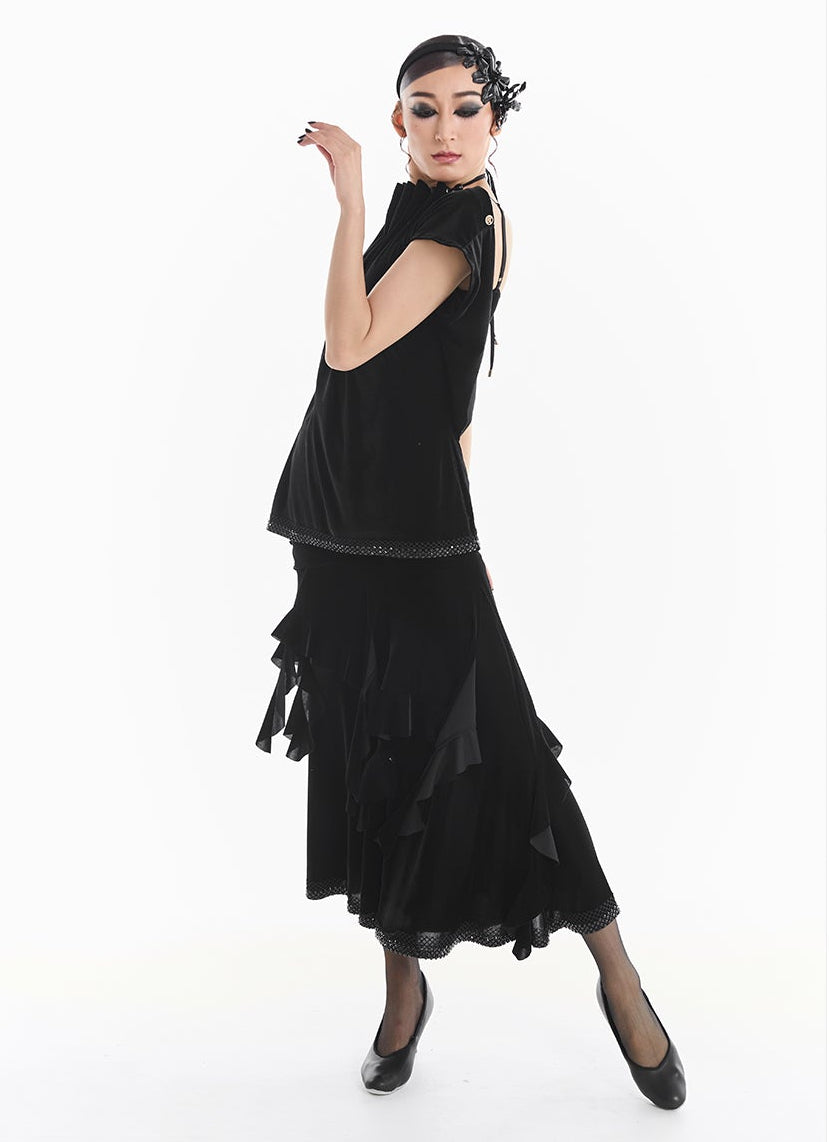 Close-up of a black dress with intricate detailing