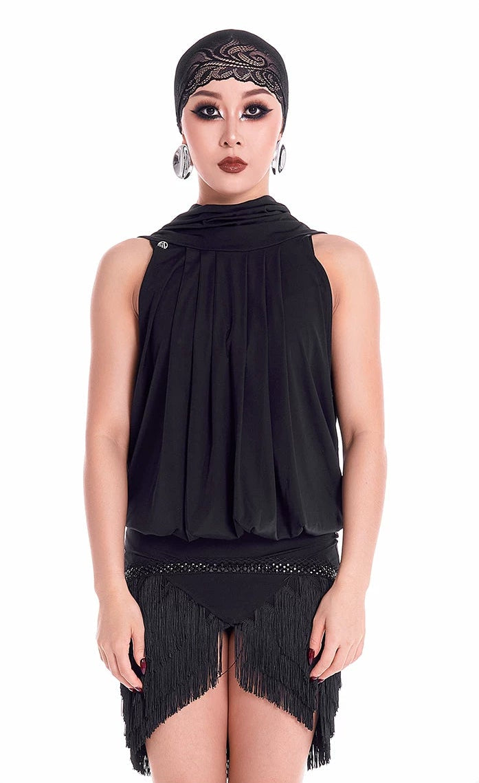 Model wearing a black sleeveless dress with fringe details on a white background