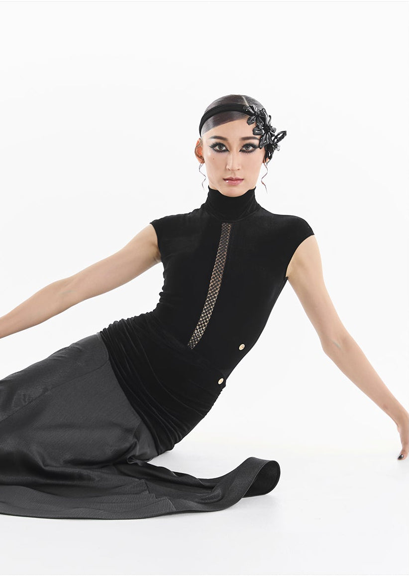 Woman wearing a black dress with a white background, featuring a brand logo.