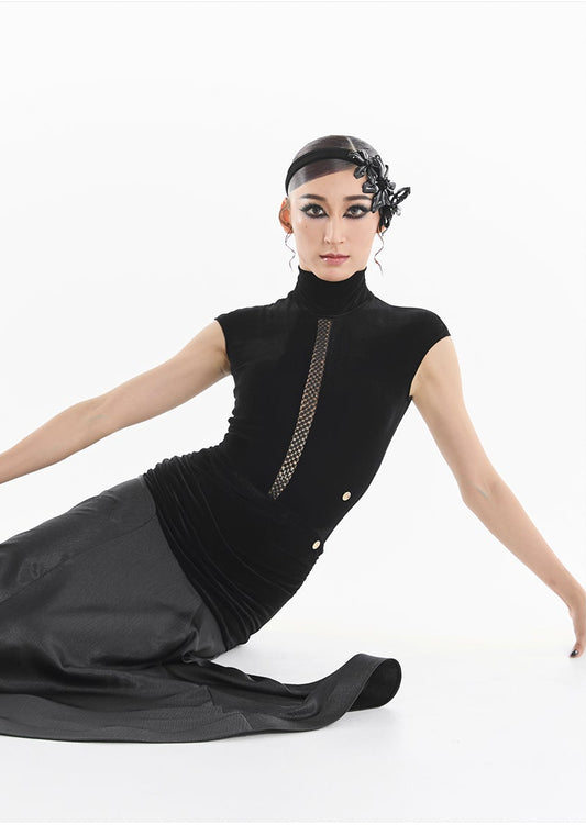 Woman wearing a black dress with a white background, featuring a brand logo.