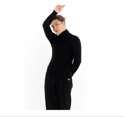 Person wearing a black outfit with a white background and brand logo.