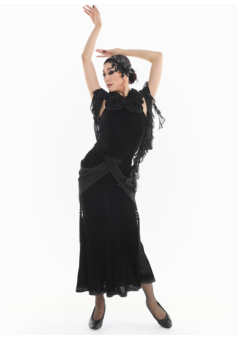 Woman in a black dress with floral details posing against a white background, featuring the brand 'DUYQ DESIGN'.