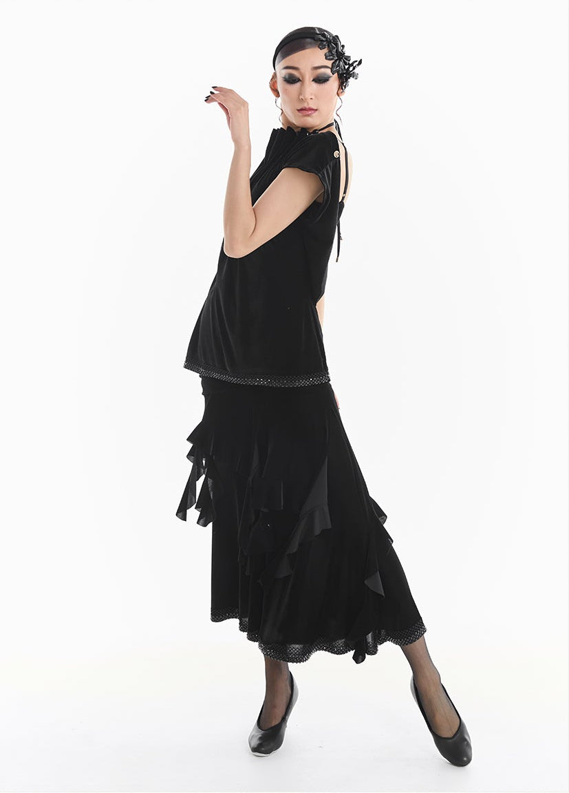 Woman wearing a black dress with ruffled details, standing against a white background with 'DUYQ DESIGN' branding.