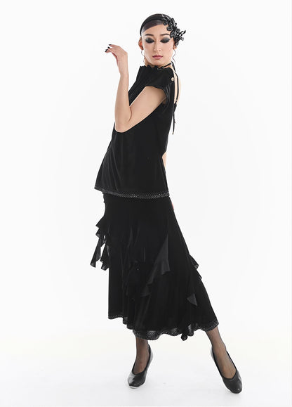 Woman wearing a black dress with ruffled details, standing against a white background with 'DUYQ DESIGN' branding.