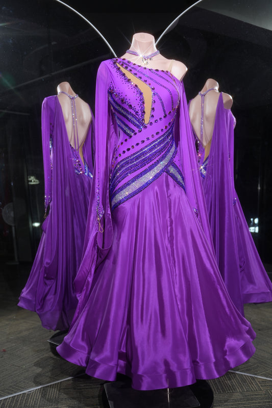 Purple ballroom dance dress with intricate designs on a mannequin.