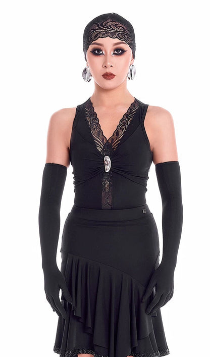 Woman wearing a black dress with lace details and long gloves on a white background