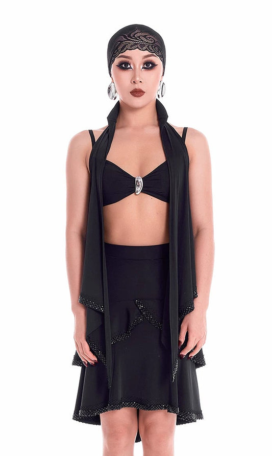 Model wearing a black outfit with a headscarf on a white background