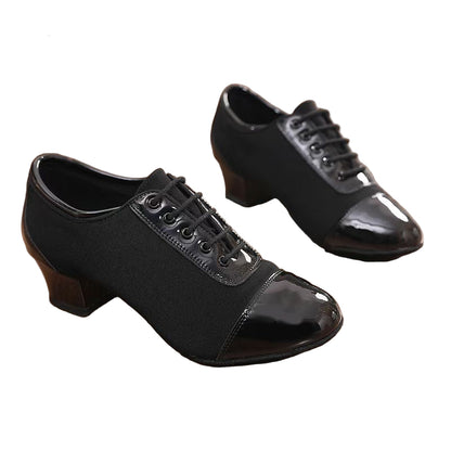 Black dance shoes with patent leather finish on a wooden floor, featuring the Drhdance brand.